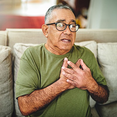 Man with hand on chest - Pulmonary Embolism or Heart Attack